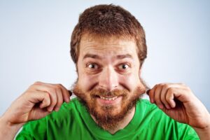 Man pulling hairy patchy beard