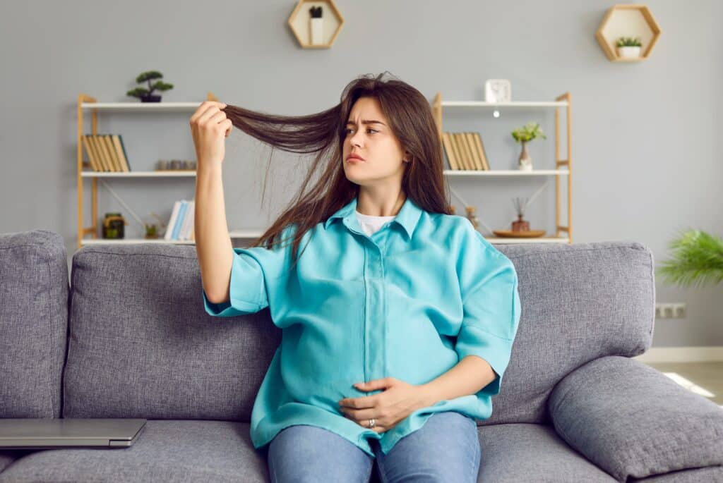 Woman experiencing hair loss during her pregnancy.