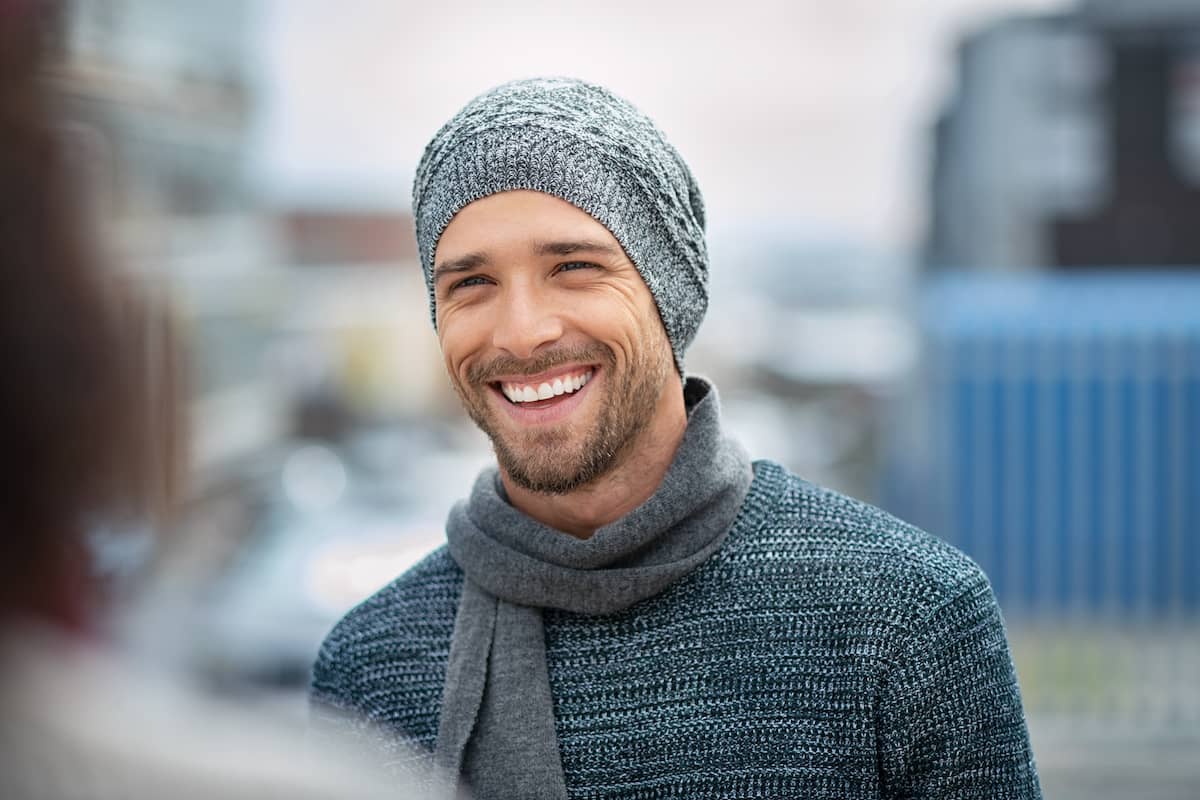 Smiling man with hat and scarf