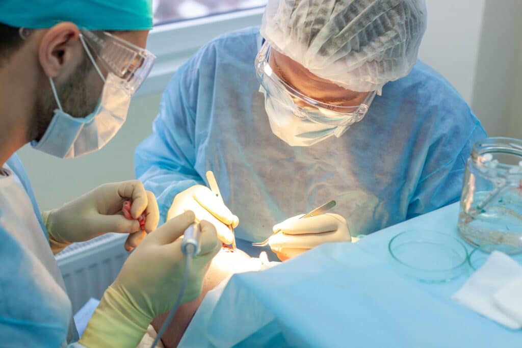 Surgeons in the operating room carry out hair transplant surgery