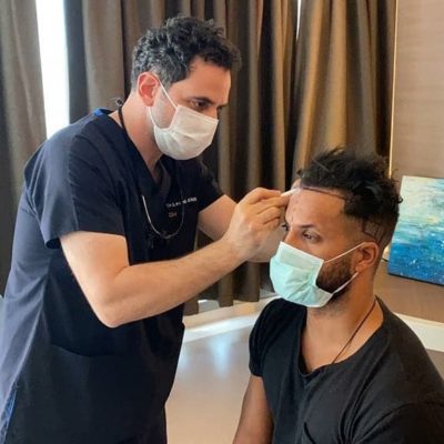 Dr Acar marking Ricky Whittle's new hairline